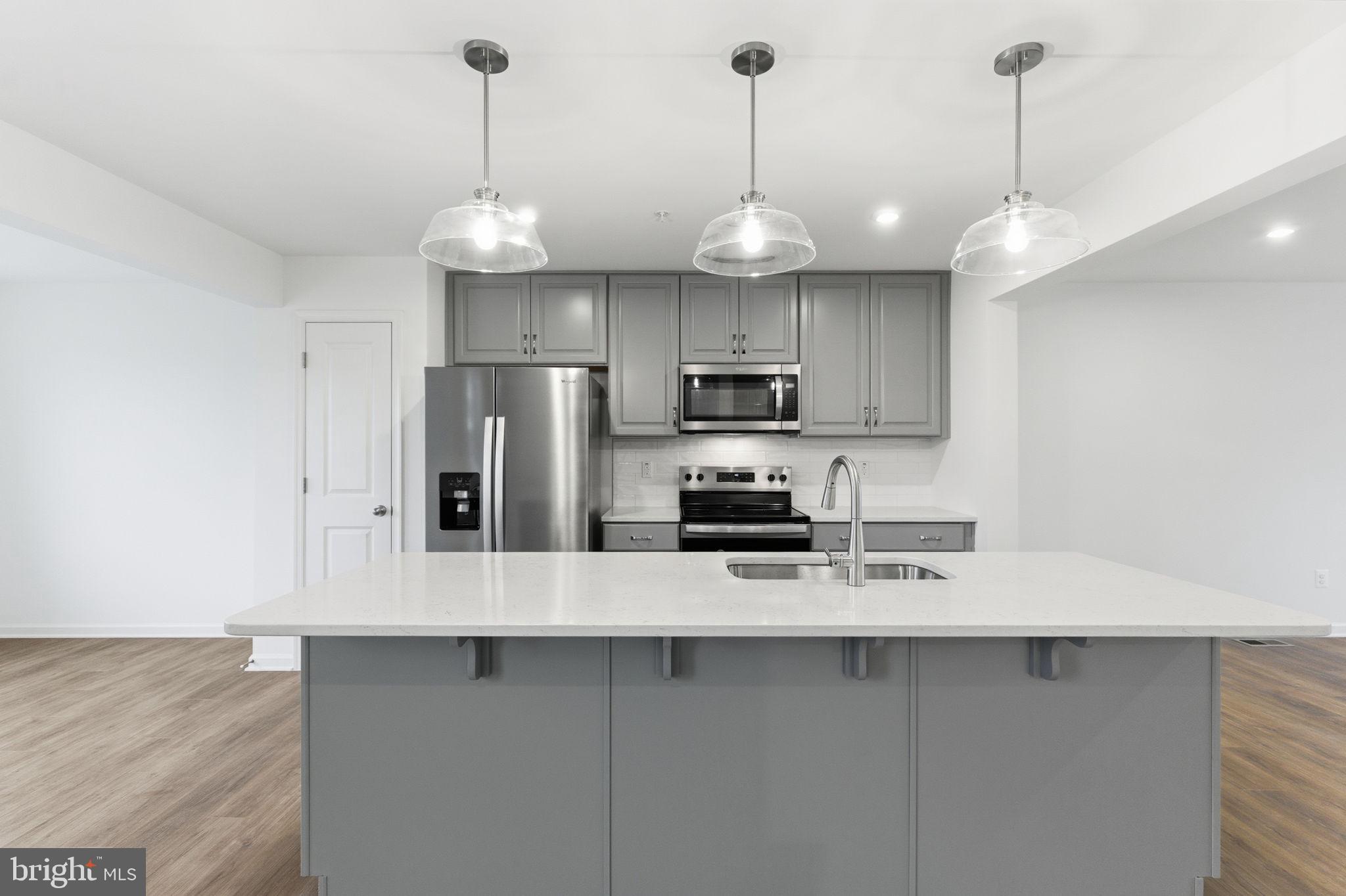 161 Homestead Drive Hanover, PA 17331 - Photo 8 of 43 a kitchen with stainless steel appliances a refrigerator a sink and a center island