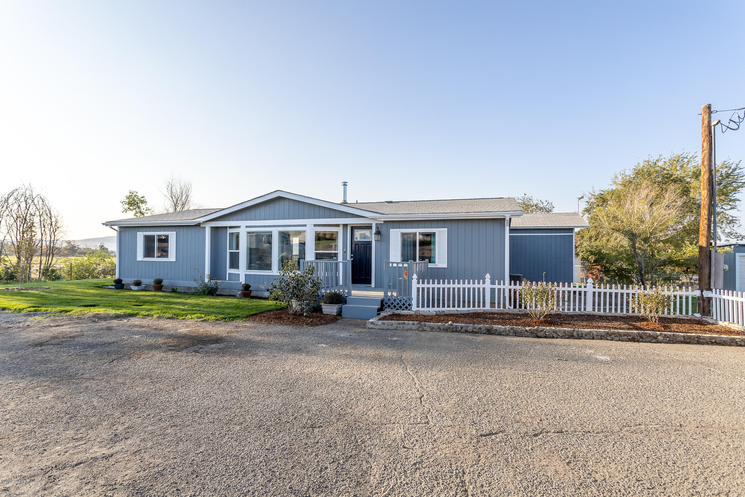 6904 Bittner Road Yakima, WA 98901 - Photo 1 of 29 a front view of a house with a yard and garage