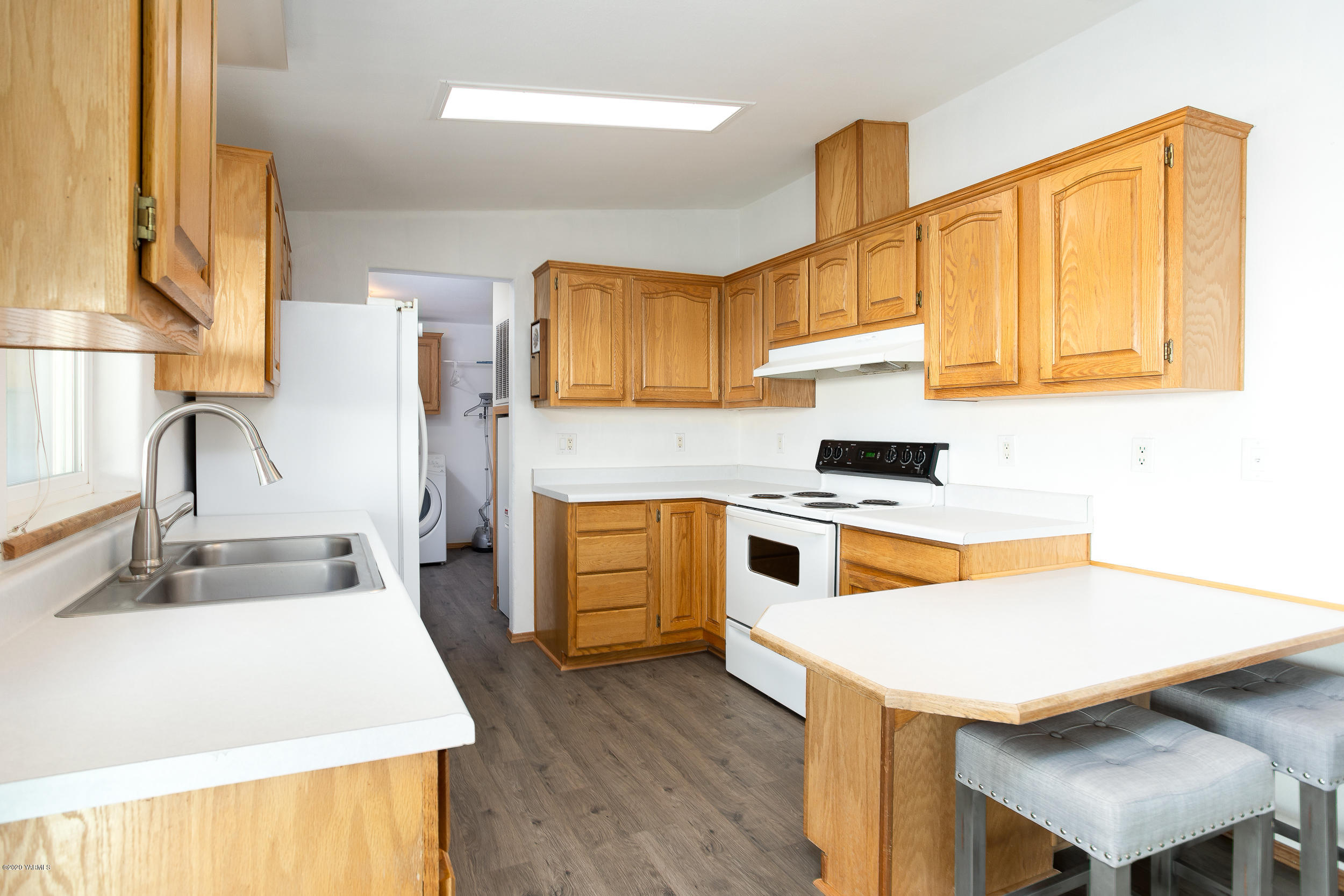 6904 Bittner Road Yakima, WA 98901 - Photo 17 of 29 a kitchen with a sink a stove and a refrigerator