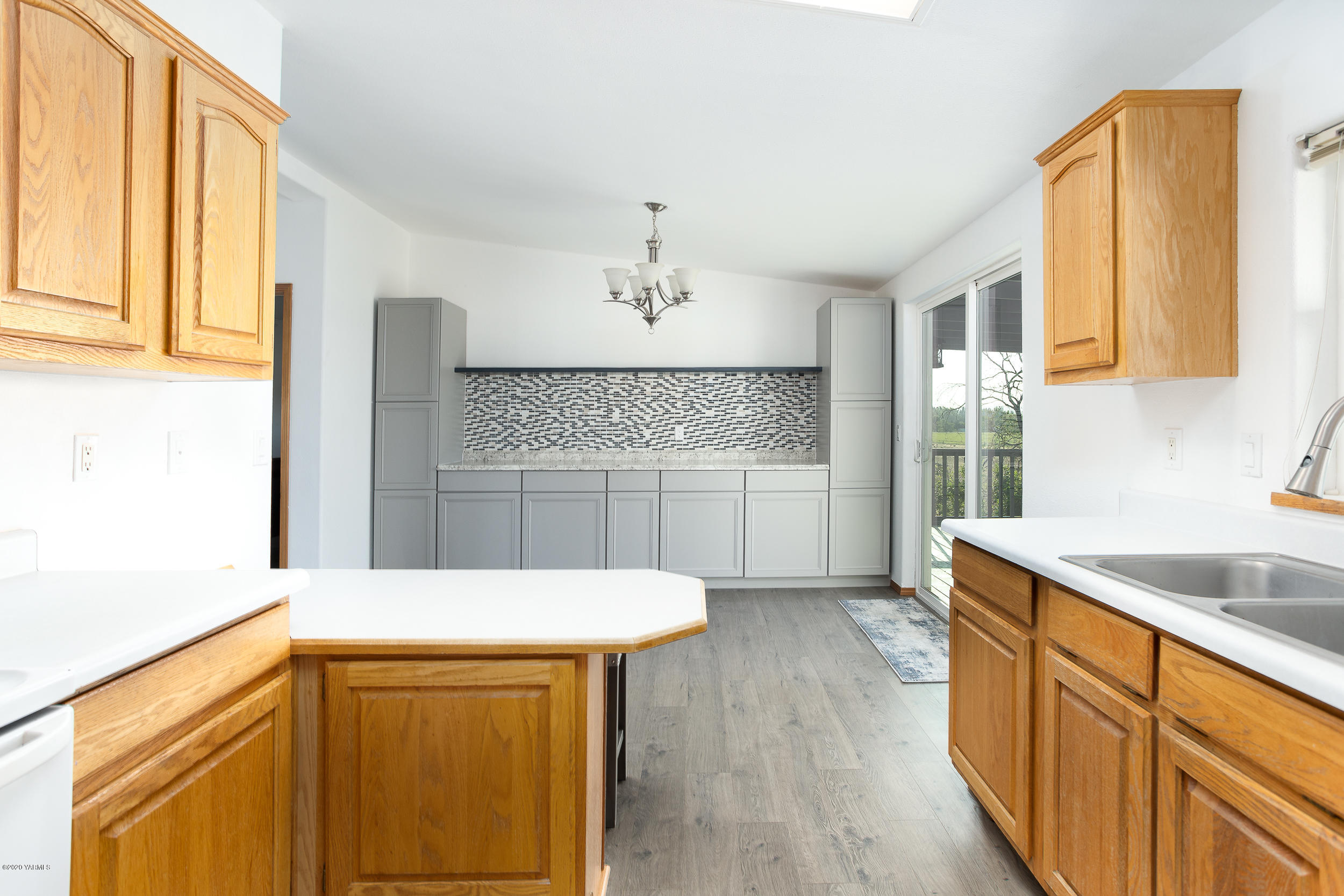 6904 Bittner Road Yakima, WA 98901 - Photo 18 of 29 a kitchen with stainless steel appliances granite countertop a sink and cabinets with wooden floor