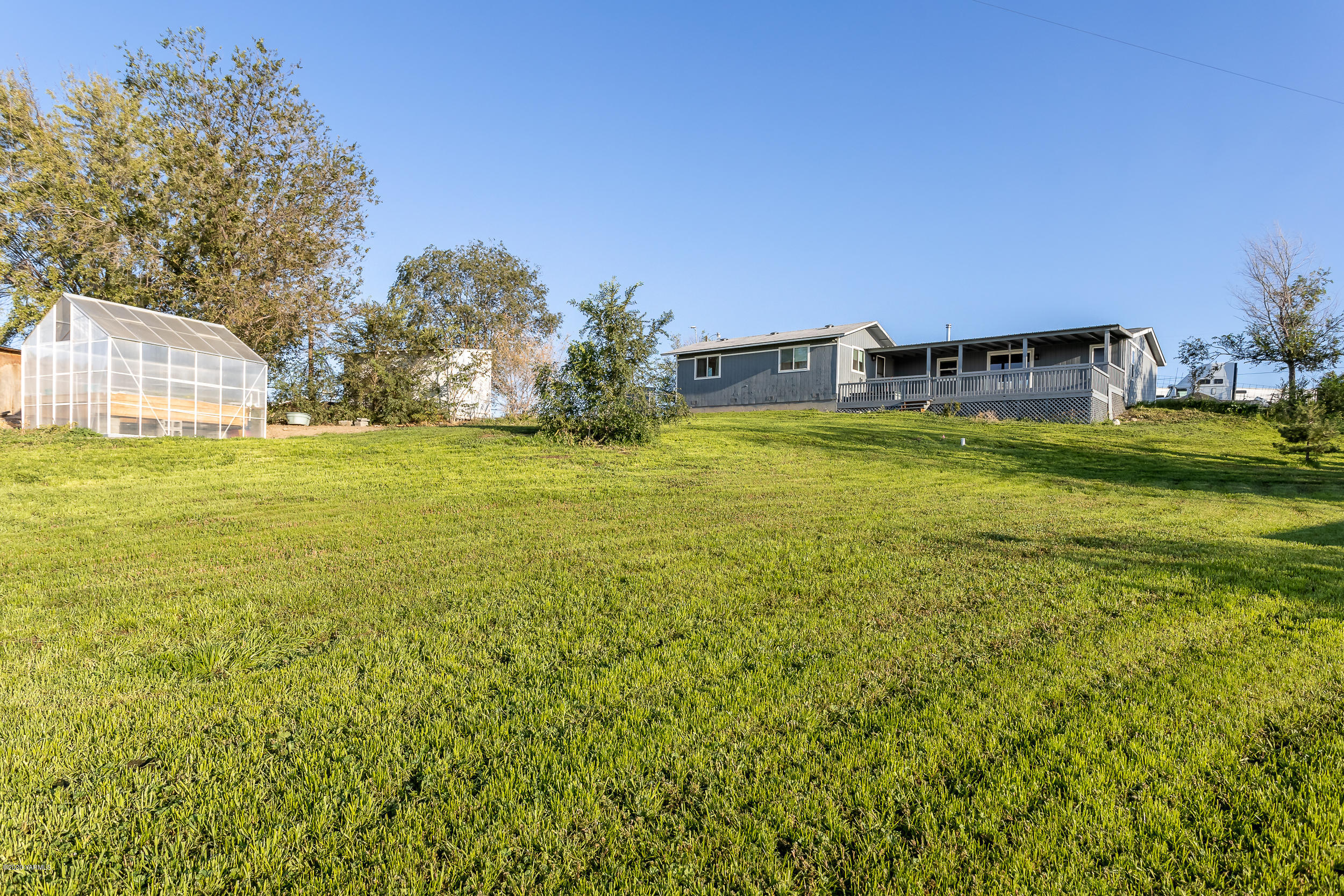 6904 Bittner Road Yakima, WA 98901 - Photo 5 of 29 a view of a large garden with plants and large trees