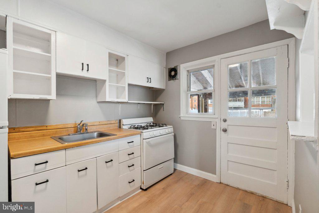 1728 Amuskai Road Baltimore, MD 21234 - Photo 11 of 30 a kitchen with white cabinets and window