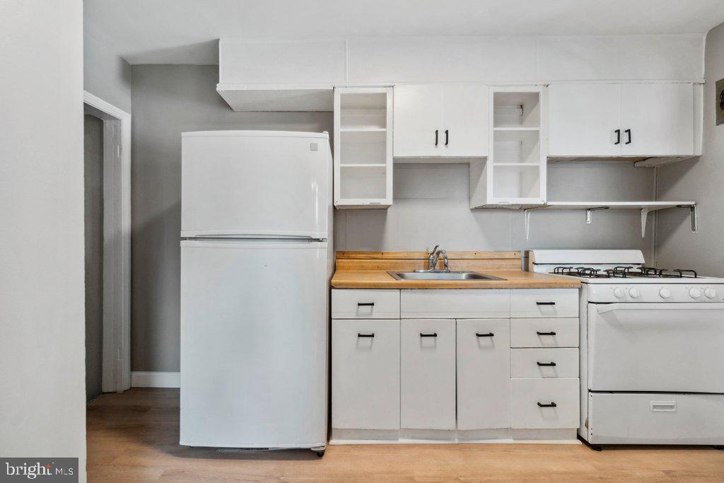 1728 Amuskai Road Baltimore, MD 21234 - Photo 13 of 30 a kitchen with cabinets appliances and a wooden cabinets