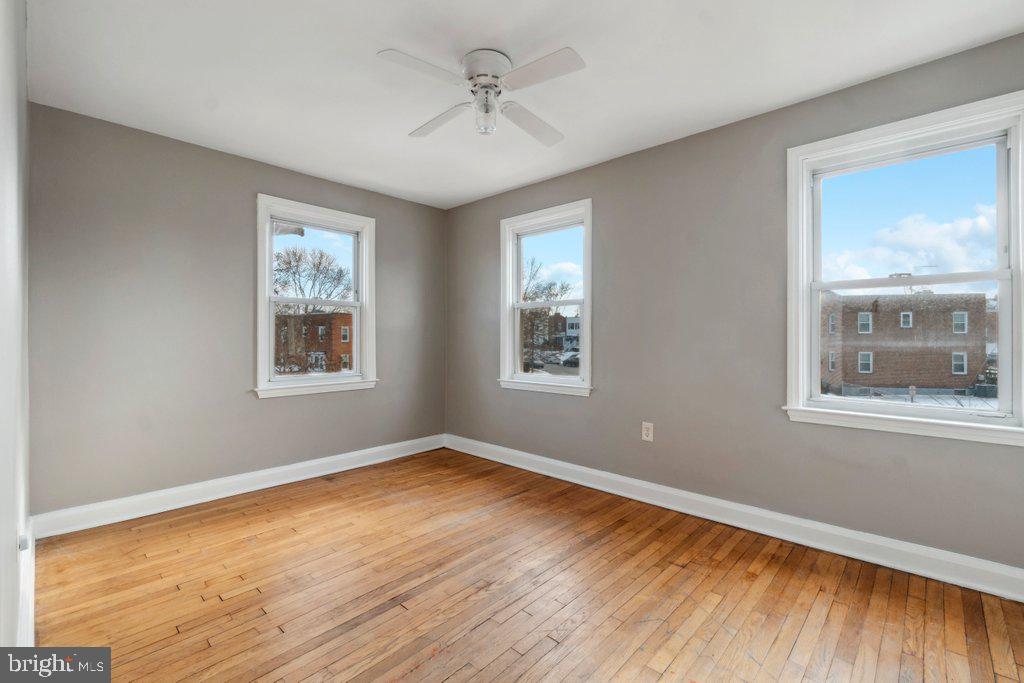 1728 Amuskai Road Baltimore, MD 21234 - Photo 21 of 30 a view of empty room with wooden floor and fan