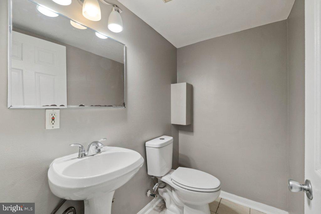 1728 Amuskai Road Baltimore, MD 21234 - Photo 27 of 30 a bathroom with a toilet sink and mirror