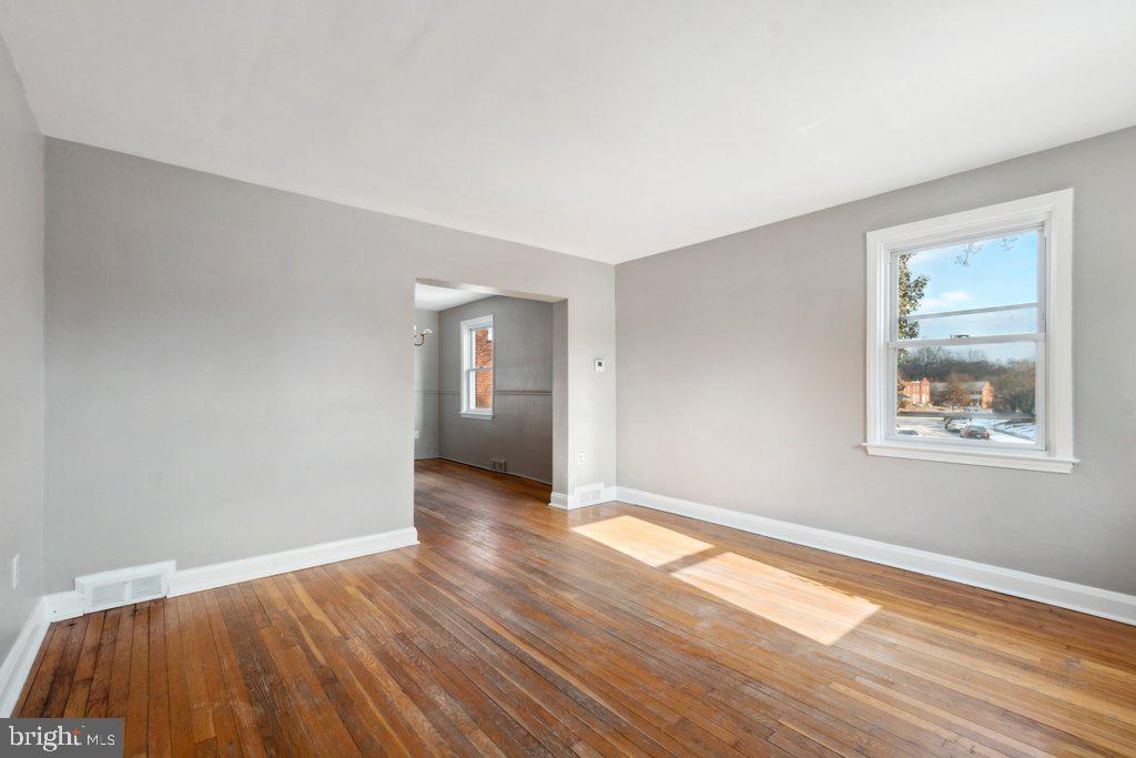 1728 Amuskai Road Baltimore, MD 21234 - Photo 5 of 30 a view of an empty room with wooden floor and a window