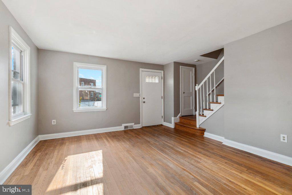 1728 Amuskai Road Baltimore, MD 21234 - Photo 6 of 30 a view of an empty room with wooden floor and a window