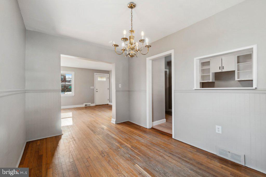 1728 Amuskai Road Baltimore, MD 21234 - Photo 9 of 30 a view of an empty room with window and wooden floor
