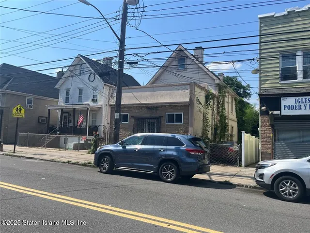 a view of a car parked in front of a house