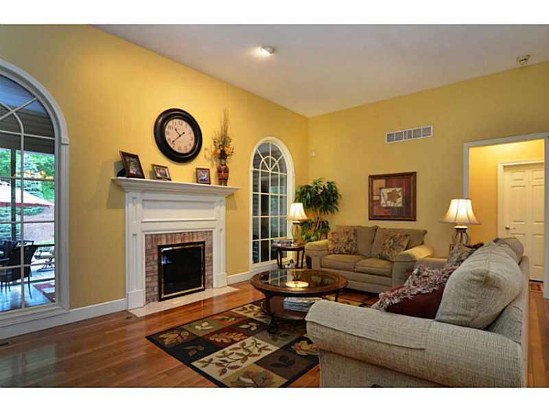 1025 Chapel Road Monaca, PA 15061 - Photo 2 of 24 Living Room. The living room offers hardwood floors, a log burning fireplace with gas starter, and large palladium windows.