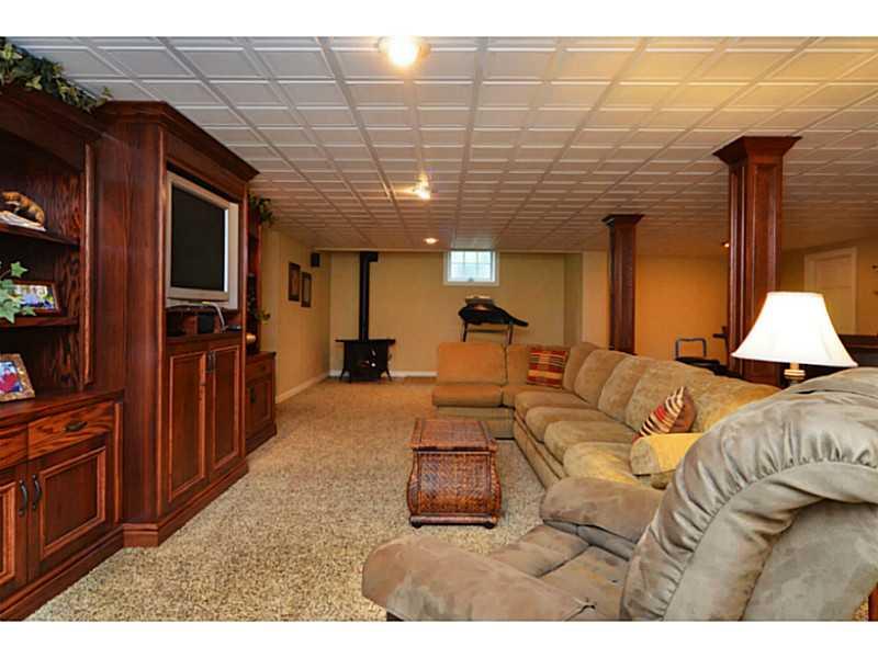 1025 Chapel Road Monaca, PA 15061 - Photo 15 of 24 Basement/Game Room. The basement includes a built-in entertainment unit and corner fireplace.