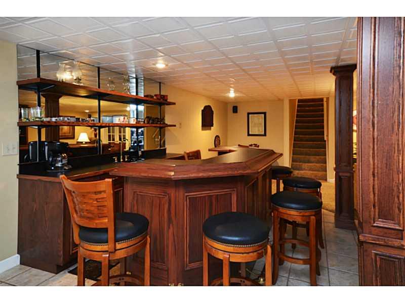 1025 Chapel Road Monaca, PA 15061 - Photo 16 of 24 Basement/Game Room. The built-in bar includes a ceramic tile floor.