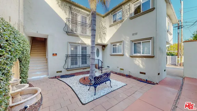 a front view of a house with outdoor seating