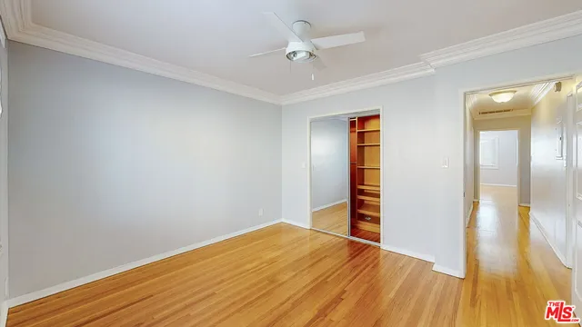 a view of empty room with wooden floor