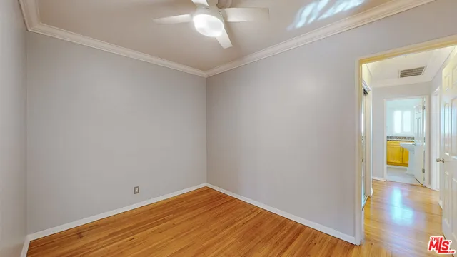 a view of a room with wooden floor