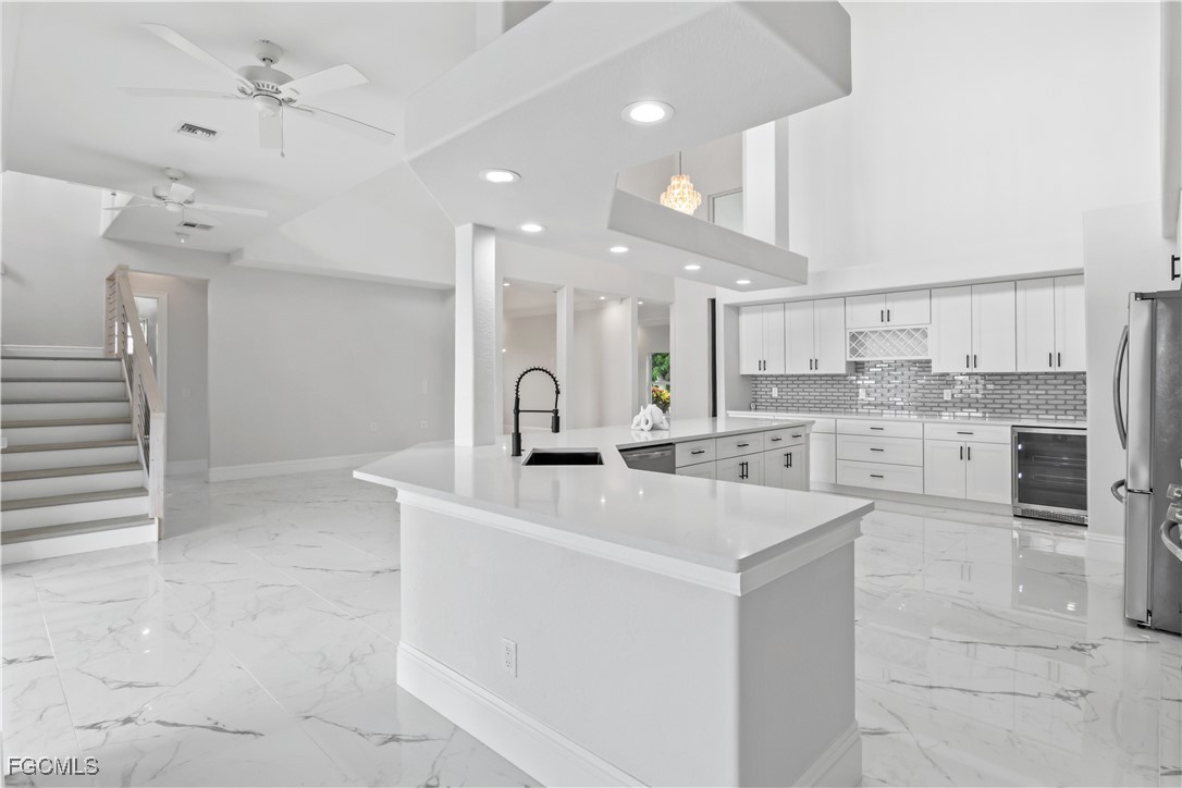 221 Old Burnt Store Road South Cape Coral, FL 33991 - Photo 20 of 49 a large kitchen with kitchen island a stove a sink a refrigerator and a stove