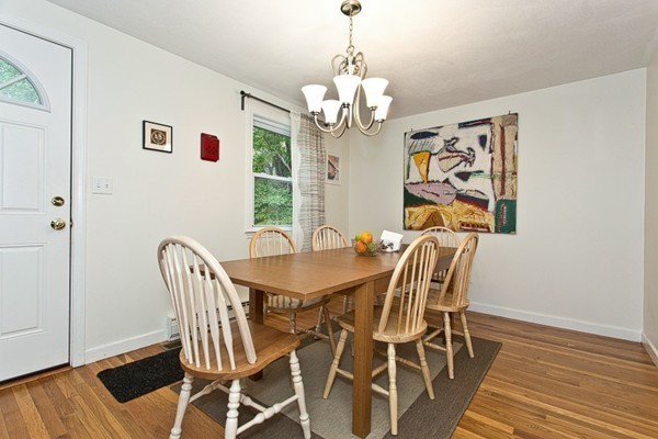 39 Thurston Road, Unit 39 Newton, MA 02464 - Photo 4 of 20 a view of a dining room with furniture wooden floor and chandelier