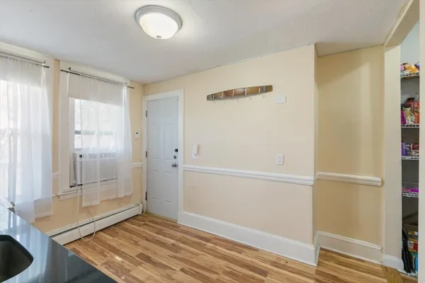 a view of a room with wooden floor and windows