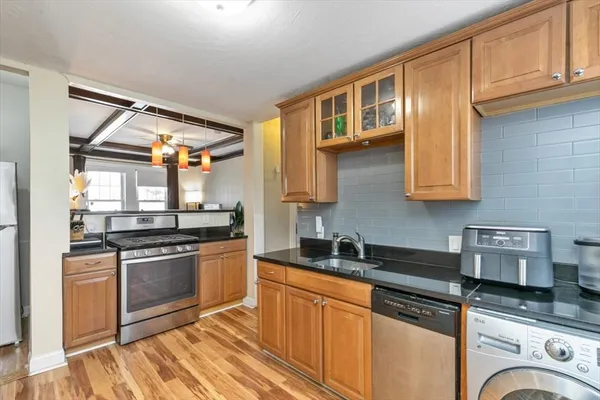 a kitchen with stainless steel appliances granite countertop a stove and a sink