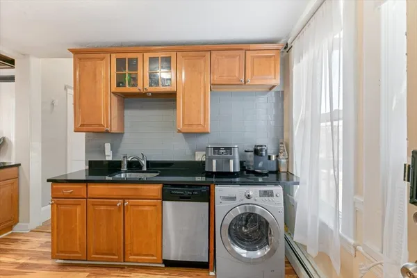 a kitchen with granite countertop a sink and a stove top oven