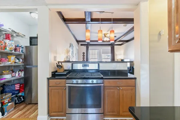 a kitchen with stainless steel appliances granite countertop a stove and cabinets