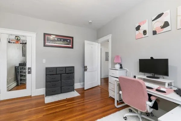 a view of a workspace with furniture and wooden floor