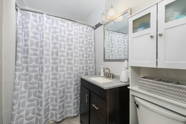 a bathroom with a sink a vanity and a shower