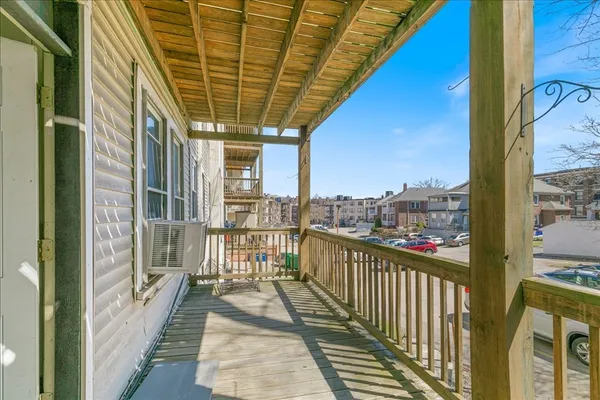 a view of a balcony with wooden floor