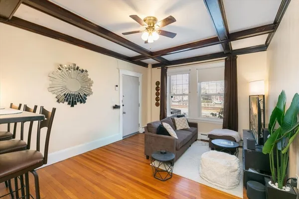 a living room with furniture and a floor to ceiling window