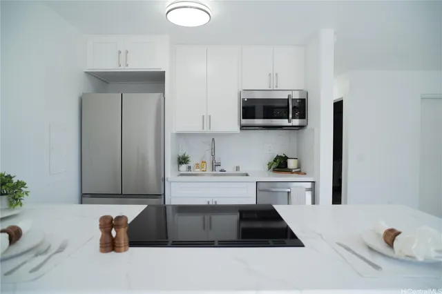 a kitchen with a sink and a stove top oven
