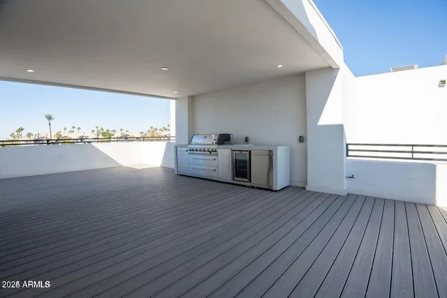 a view of a kitchen with wooden floor and electronic appliances