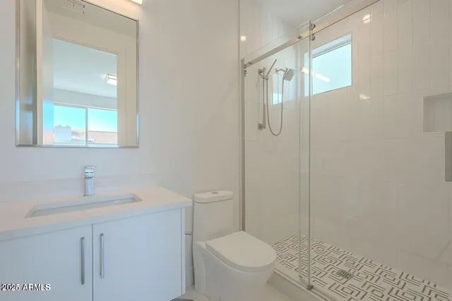 a bathroom with a sink toilet and shower