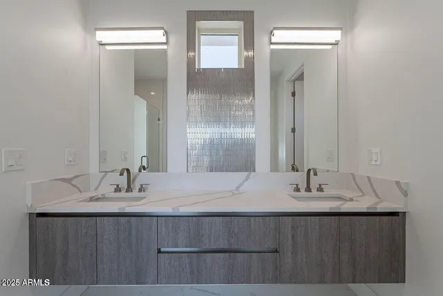 a bathroom with a sink double vanity and a mirror