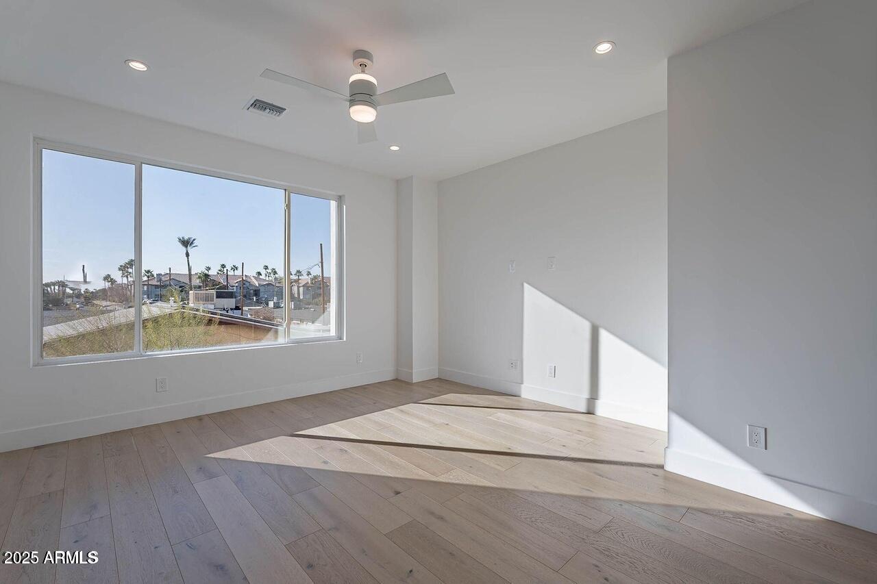 2130 East Turney Avenue, Unit 4 Phoenix, AZ 85016 - Photo 6 of 15 a view of an empty room with kitchen and window