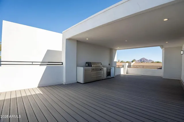 a view of a big room with wooden floor kitchen view and a window