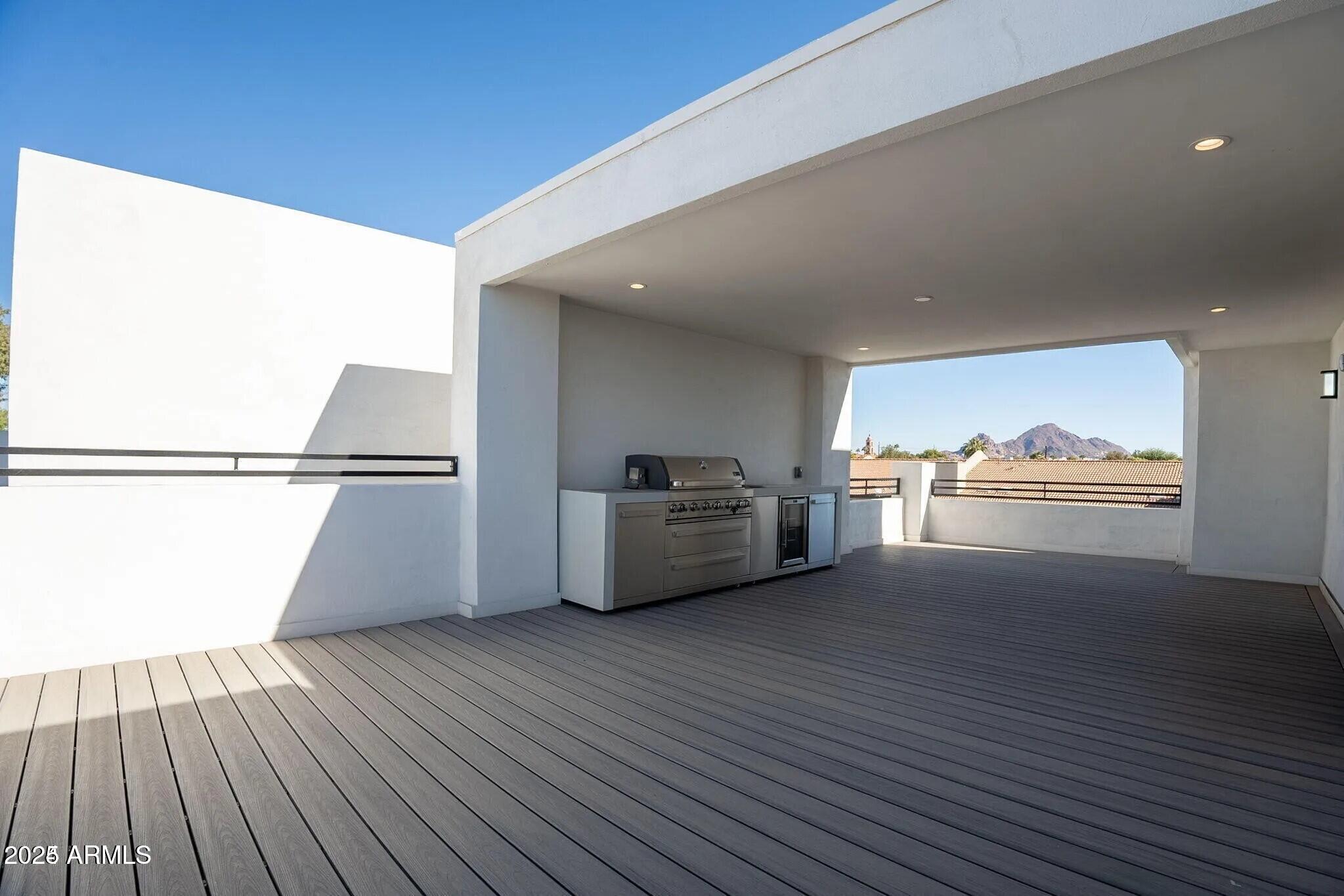 2130 East Turney Avenue, Unit 4 Phoenix, AZ 85016 - Photo 8 of 15 a view of a big room with wooden floor kitchen view and a window