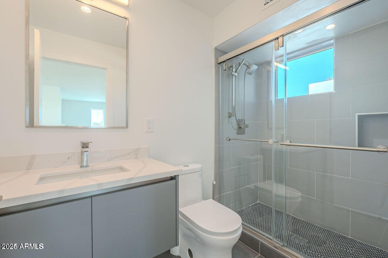 2130 East Turney Avenue, Unit 4 Phoenix, AZ 85016 - Photo 10 of 15 a bathroom with a sink a toilet and shower