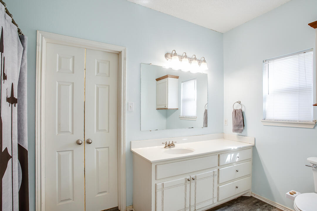 905 11th Street Wolfforth, TX 79382 - Photo 11 of 18 a bathroom with a double vanity sink and a mirror