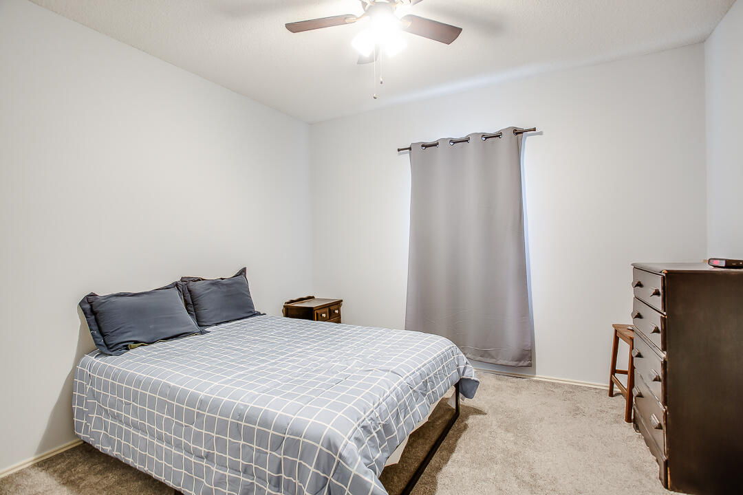 905 11th Street Wolfforth, TX 79382 - Photo 12 of 18 a bedroom with a bed and a flat tv screen on the dresser