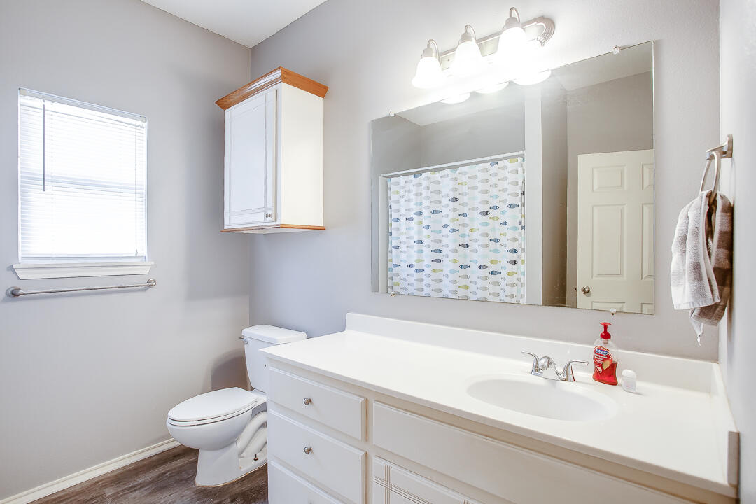 905 11th Street Wolfforth, TX 79382 - Photo 14 of 18 a bathroom with a sink toilet and shower