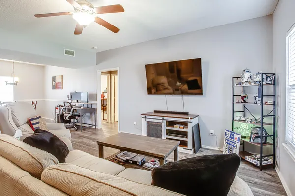 a living room with furniture and a flat screen tv
