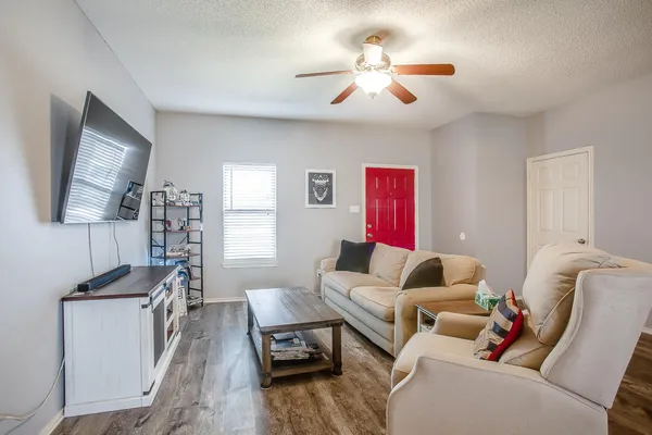 a living room with furniture and a flat screen tv