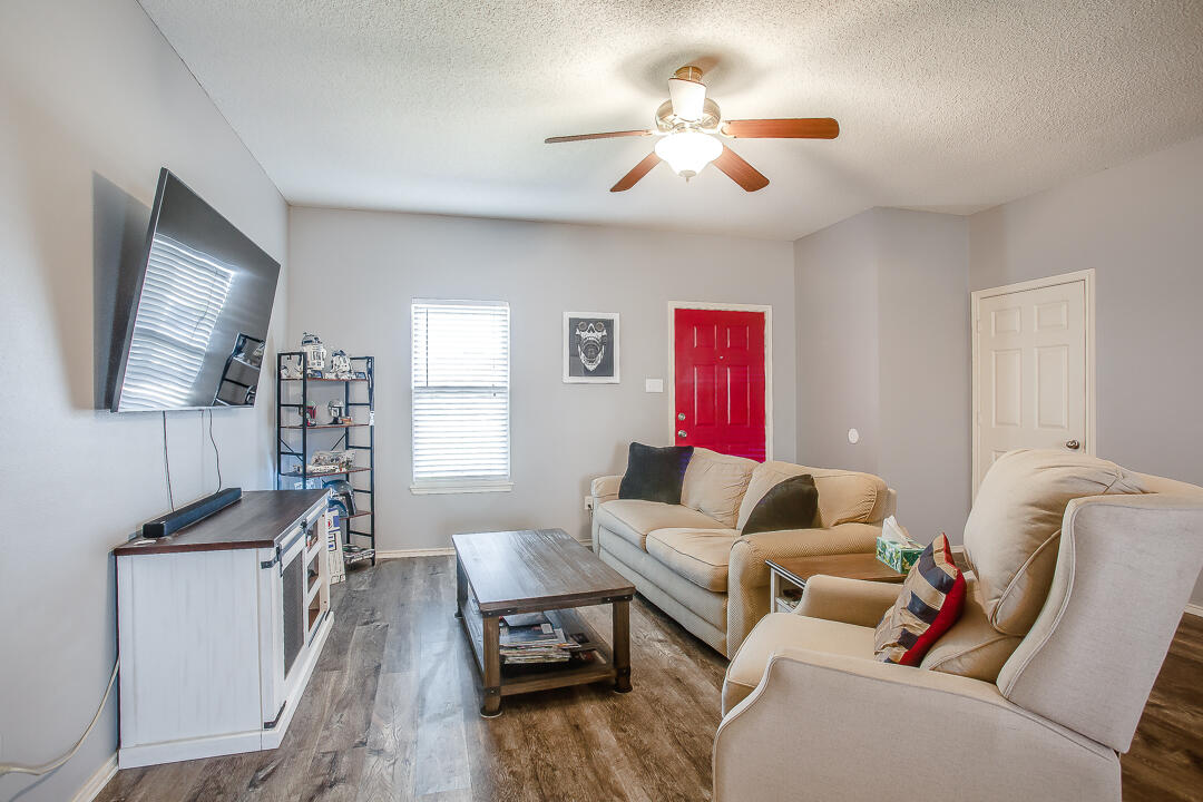 905 11th Street Wolfforth, TX 79382 - Photo 5 of 18 a living room with furniture and a flat screen tv