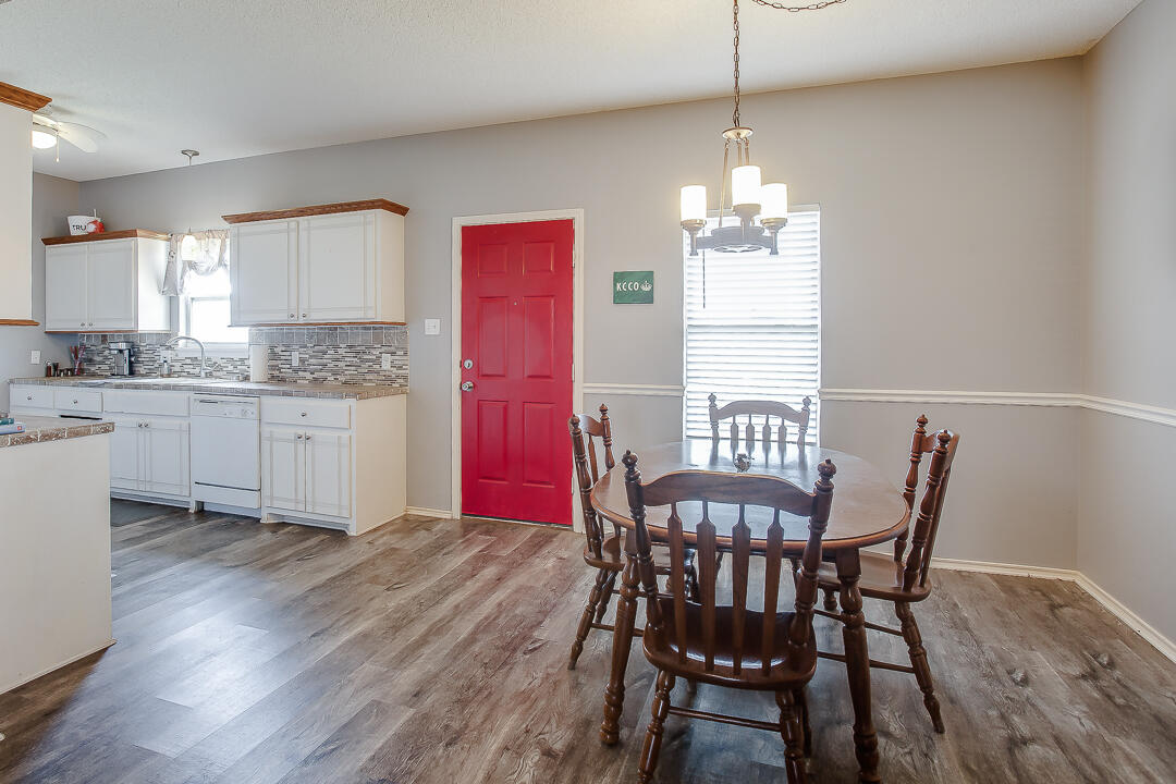 905 11th Street Wolfforth, TX 79382 - Photo 6 of 18 a view of a dining room with furniture window and wooden floor