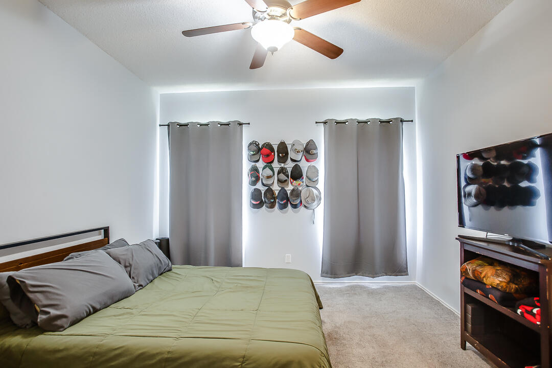 905 11th Street Wolfforth, TX 79382 - Photo 10 of 18 a bedroom with a bed and a flat screen tv
