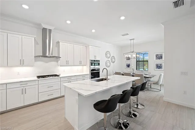 a kitchen with appliances cabinets and wooden floor