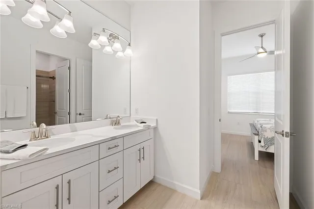 a bathroom with a double vanity sink and a mirror