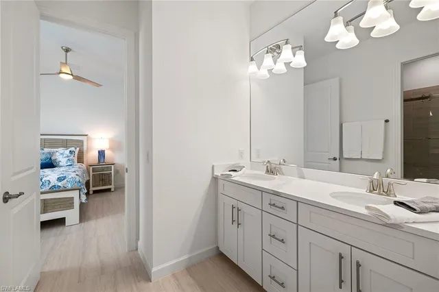 a en suite bathroom with a double vanity sink and a mirror