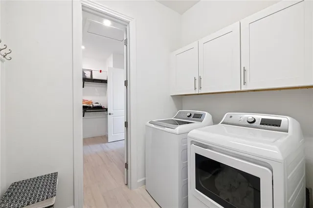 a view of storage and utility room with washer and dryer