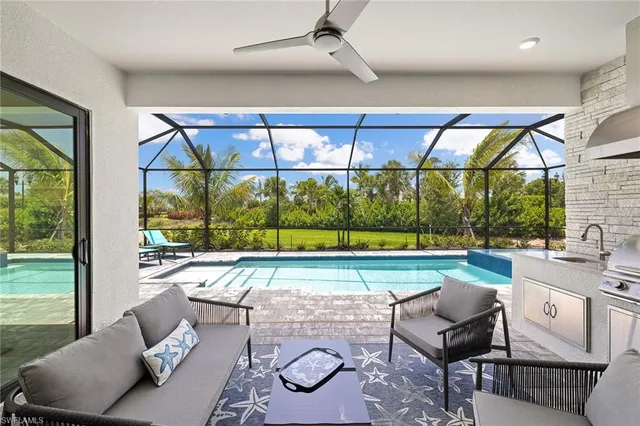 a swimming pool with outdoor seating and yard